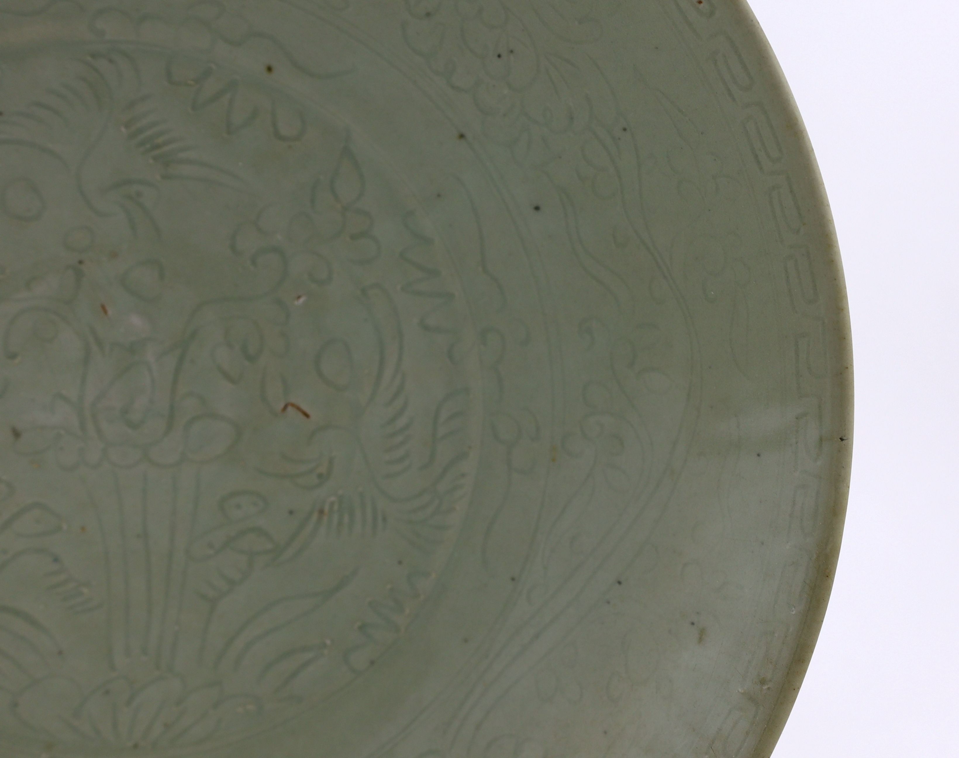 A Chinese celadon glazed sgraffito dish, Zhangzhou kilns, late 16th/early 17th century, 37cm diameter